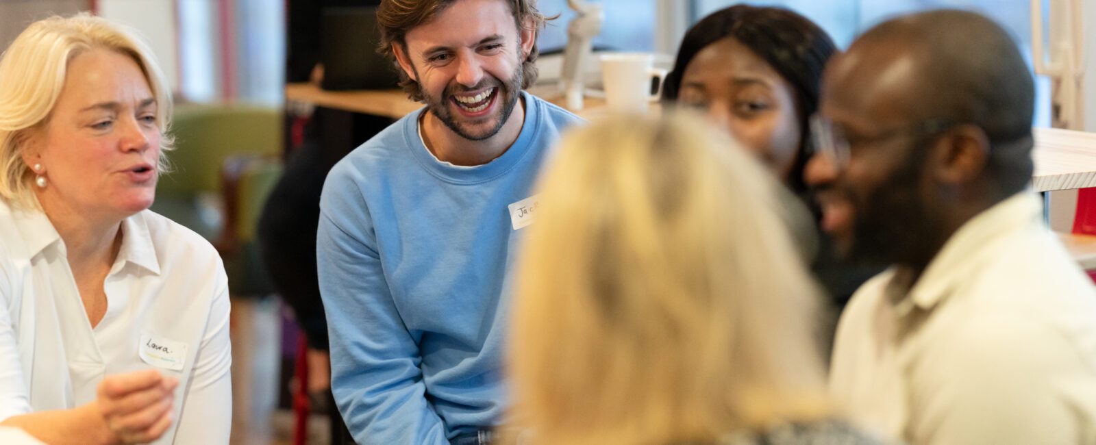 A group of ComputerXplorers franchisees are chatting and laughing and catching up on franchisee life